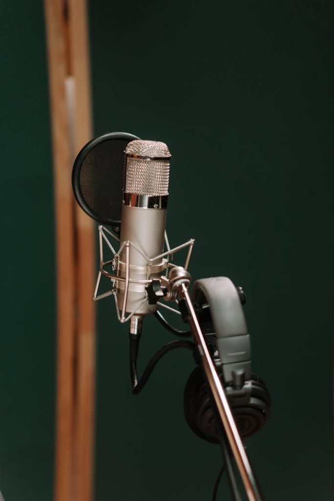 Close-up of a studio microphone with headphones, ideal for recording and broadcasting.