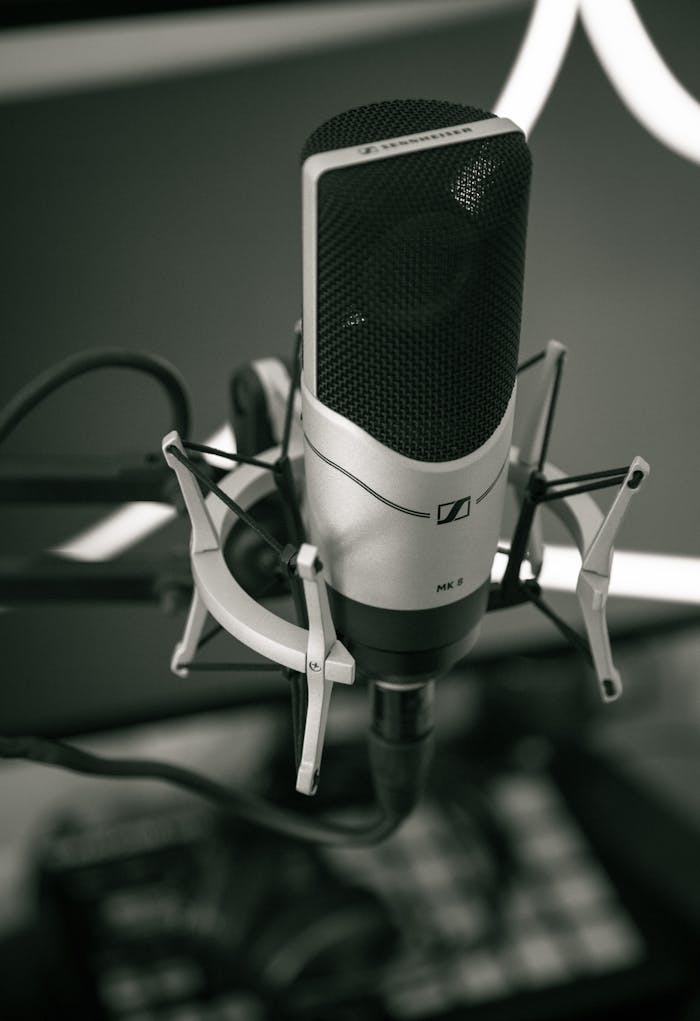 Close-up of a sleek microphone setup in a modern recording studio, capturing sound with precision.